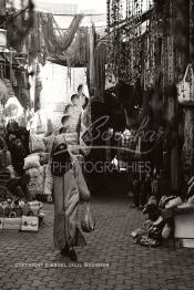 Image du Maroc Professionnelle de  Une femme marocaine traditionnellement vêtue passe par le centre du Souk des Teinturiers, appelé souk Sebbaghine, l'un des plus pittoresque de Marrakech situé dans la Médina, non loin de la source Mouassine, où quelques petits ateliers pratiquent encore de nos jours la teinture traditionnelle. Ce lieu très prisé des touristes et amateurs photos qui désire ardemment des images extrêmement colorées. Avec le temps il est devenu presque une des attractions touristique qui vaut le détour, le 8 Décembre 2018. (Photo / Abdeljalil Bounhar)